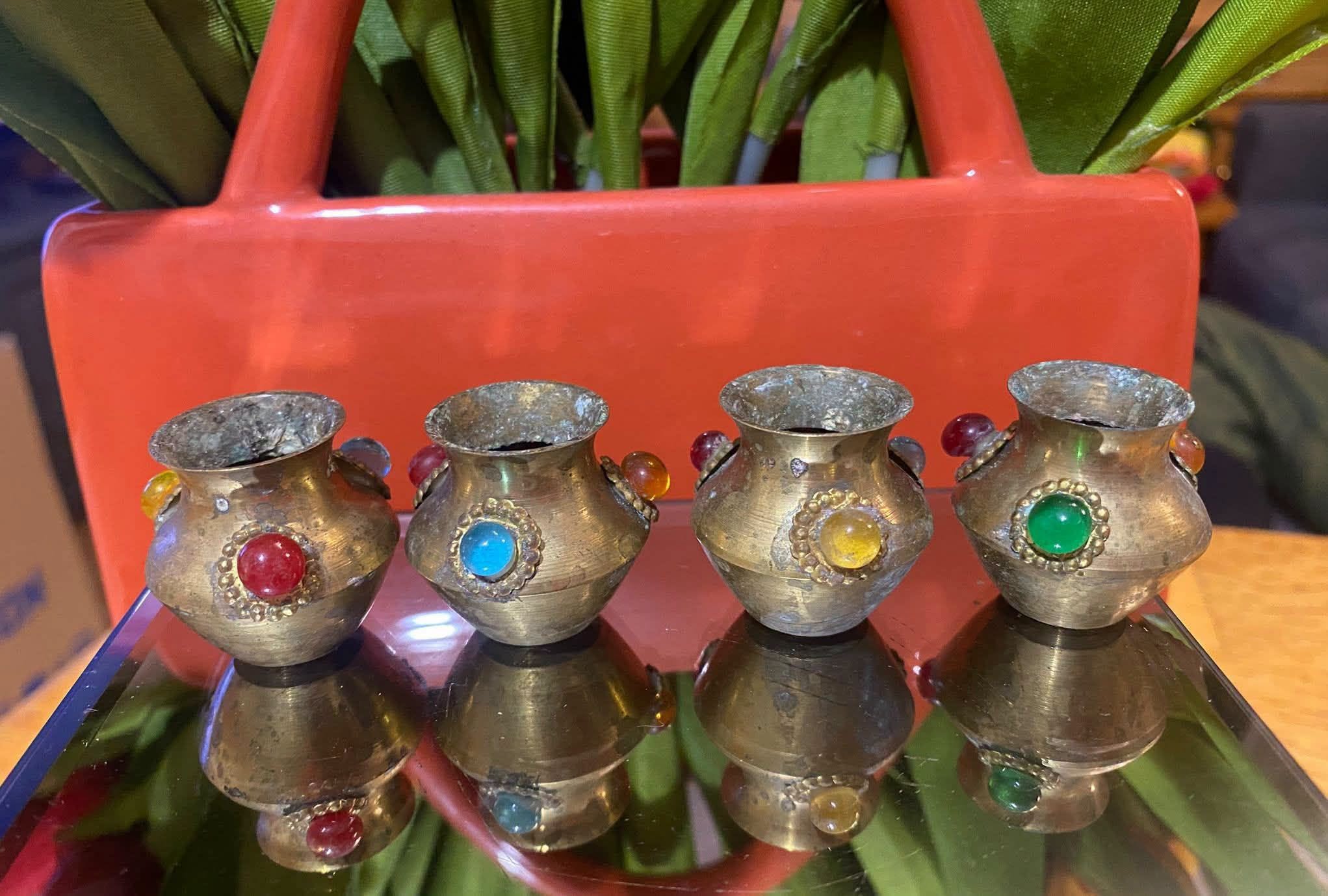 Four brass miniature vases with colored stones