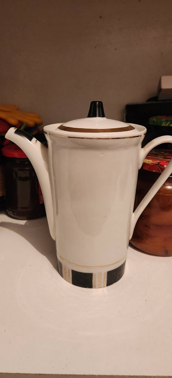 White porcelain coffee pot with black and gold trim