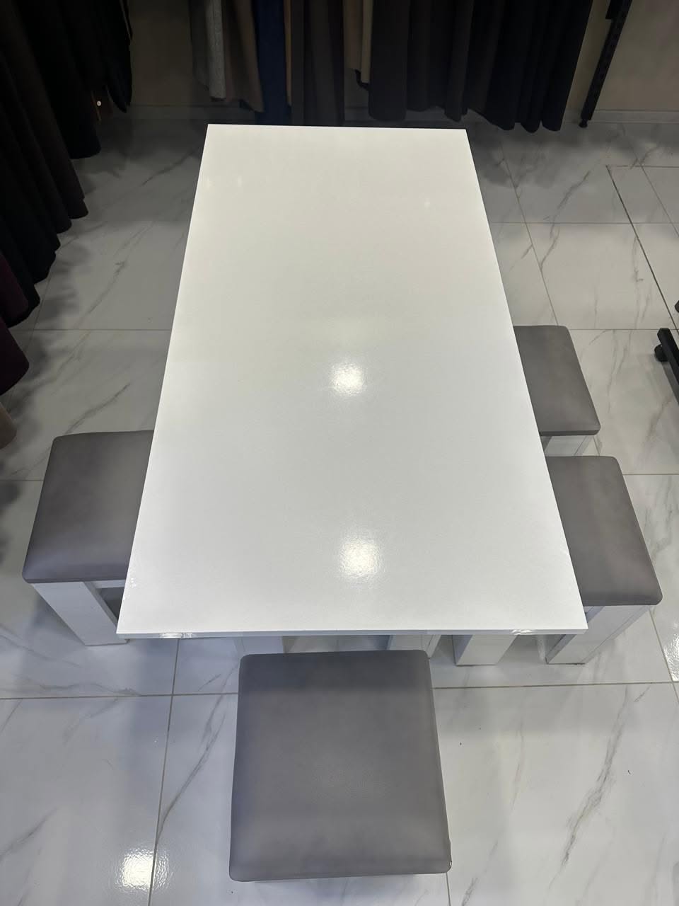 White table with four grey stools