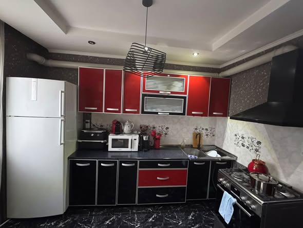 Used kitchen with fridge and extractor hood