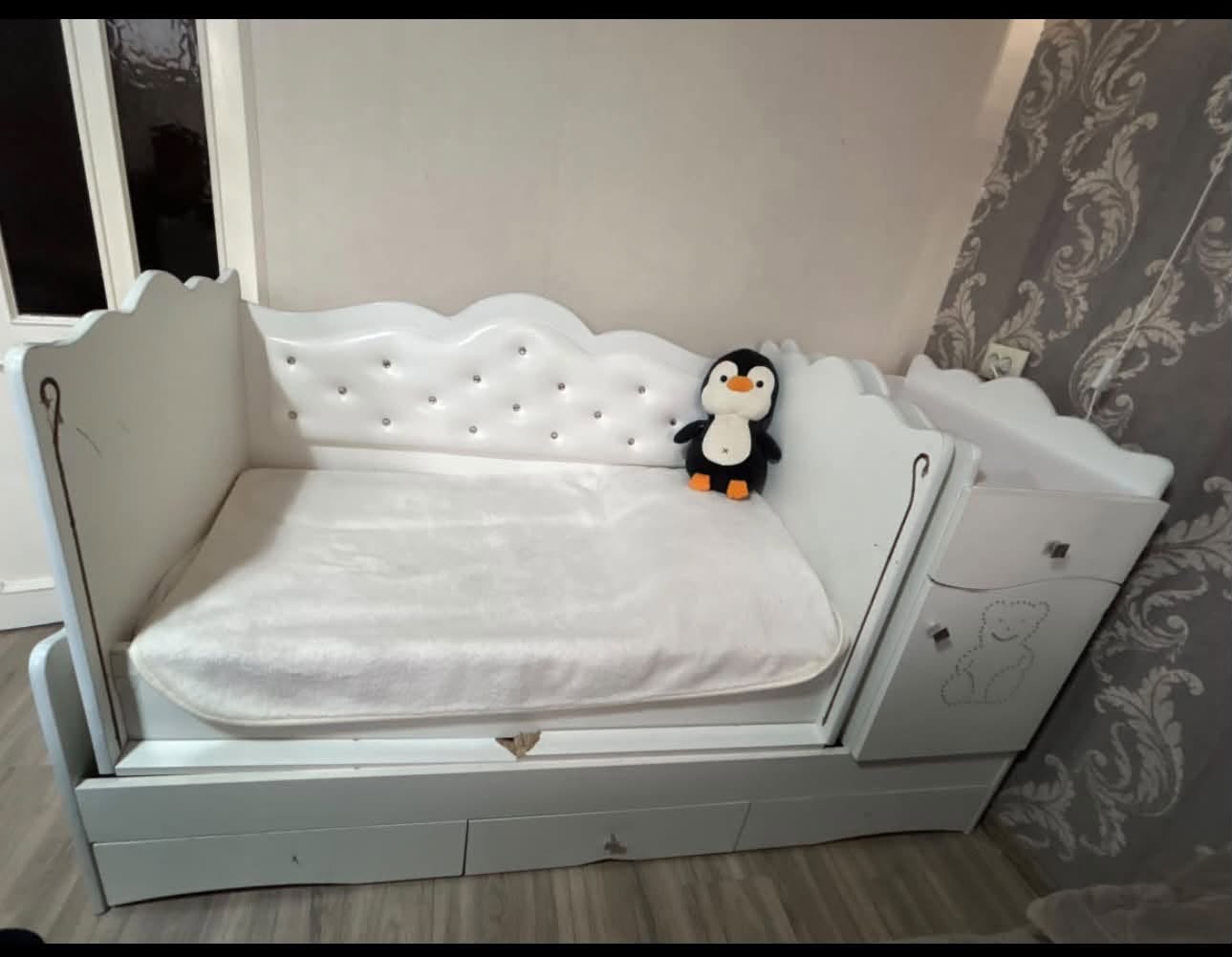 White wooden kids' bed with drawers