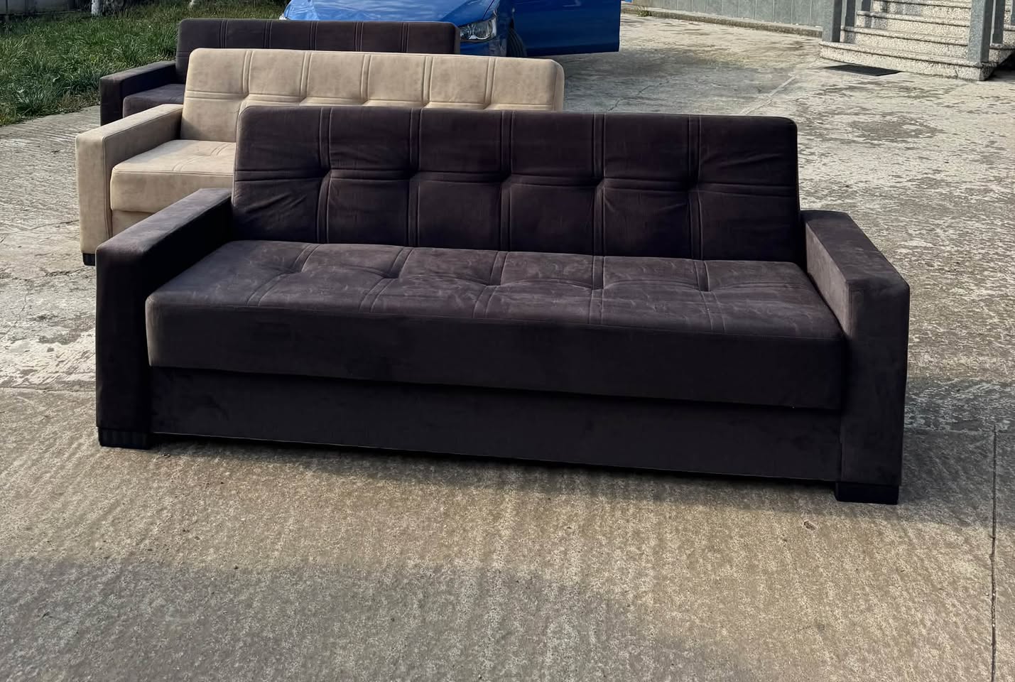Brown velvet sofa with a tufted back