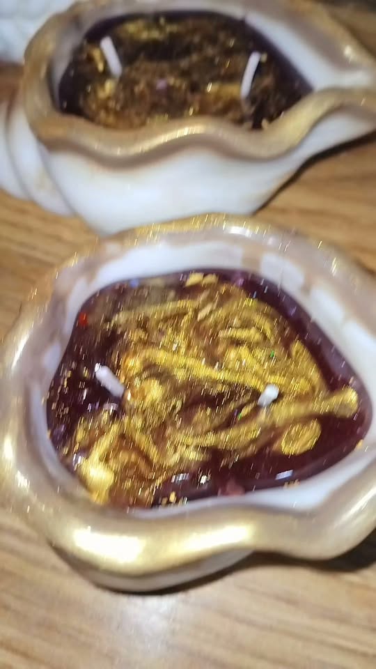 Handmade gold candles in ceramic bowl