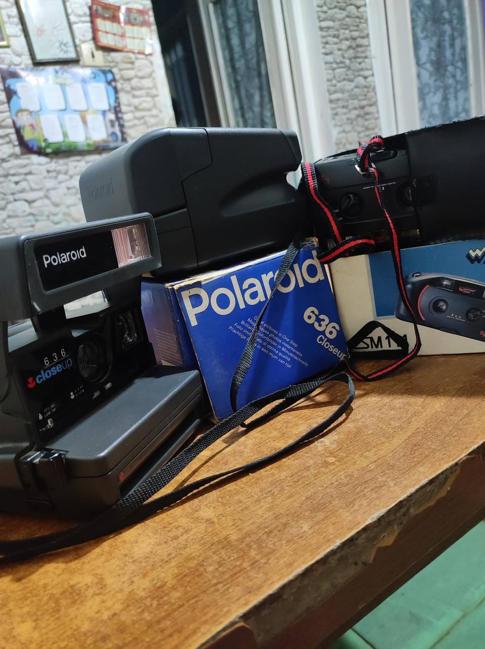 Two Polaroid and camera