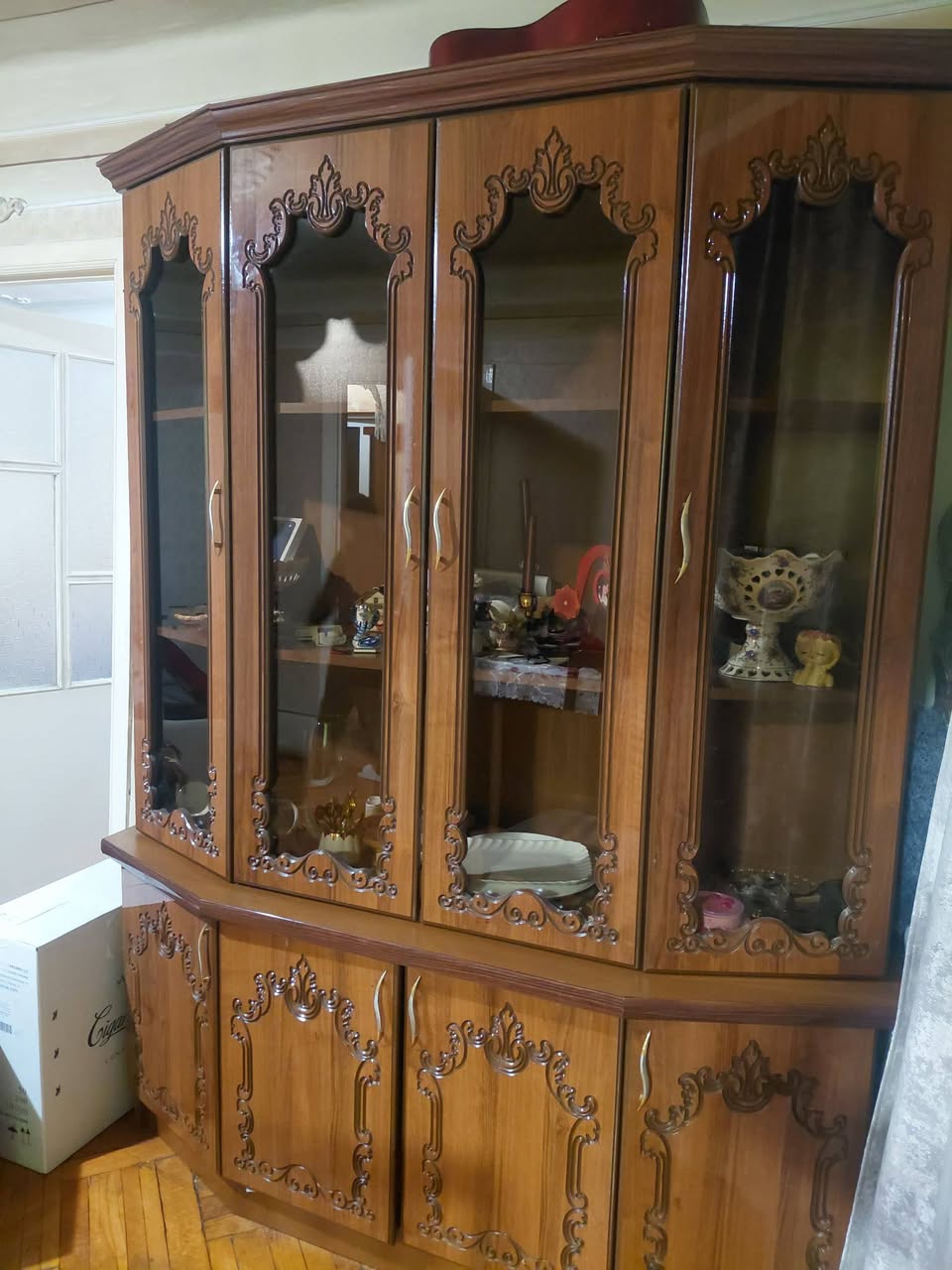 Wooden glass display cabinet with carved front