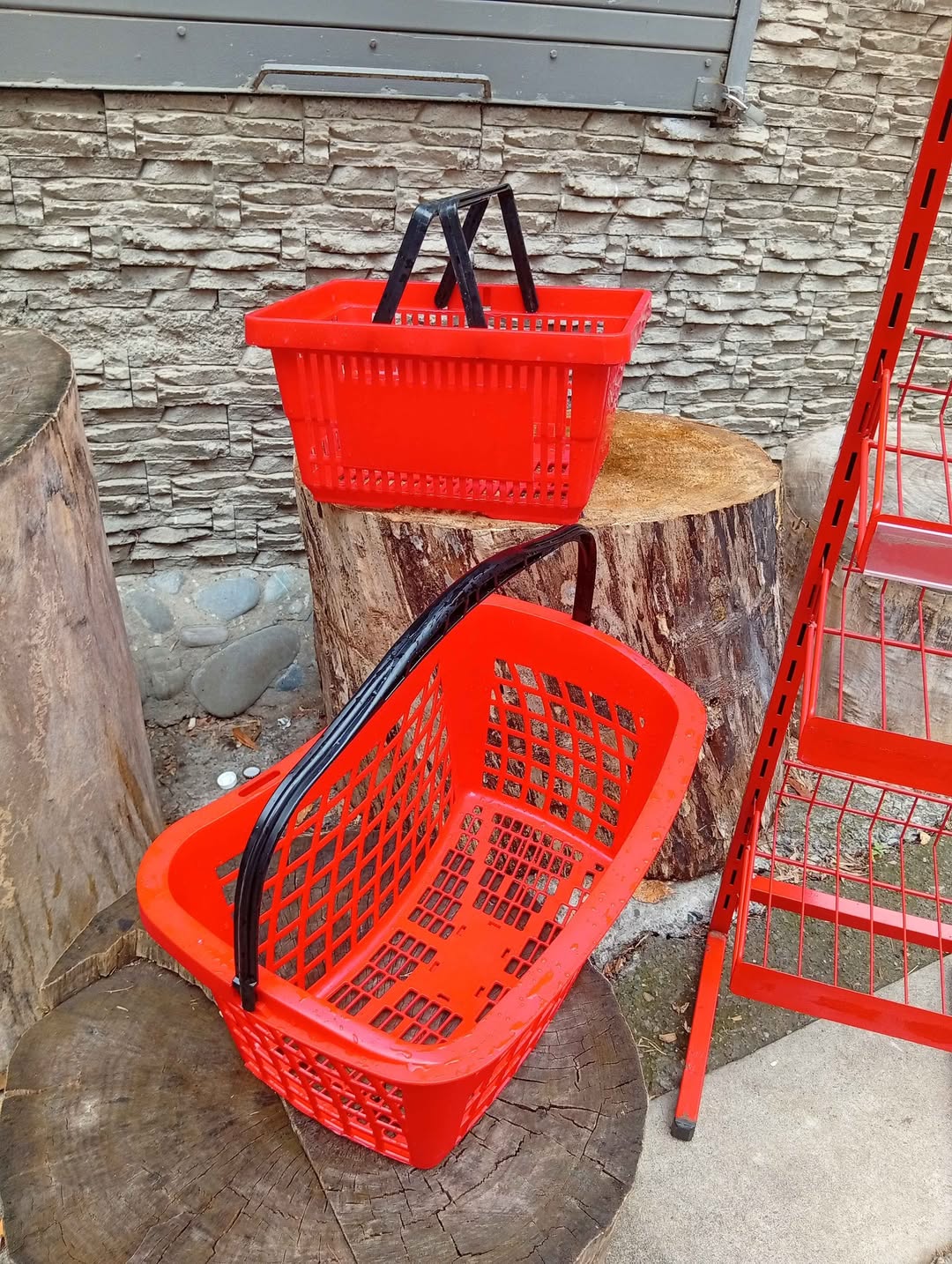 Two red shopping baskets, undamaged